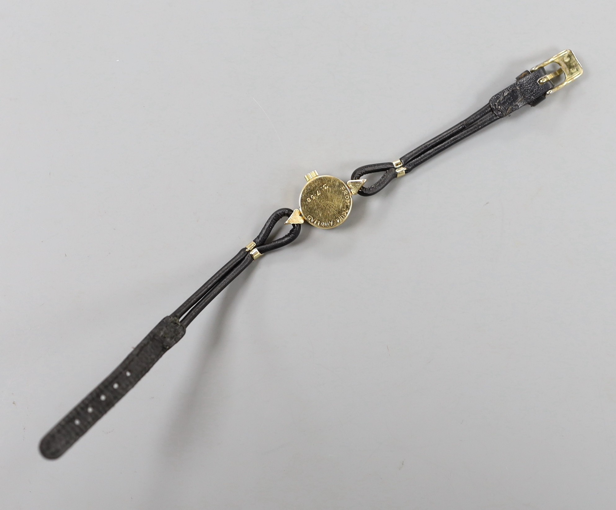 A lady's mid 20th century 750 yellow metal Rolex Orchid manual wind wrist watch, with engraved inscription, on associated leather strap.